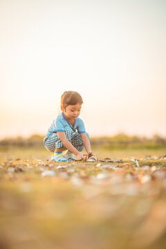 baby girl with happy time on freedom in emotional in outdoor by play throw leaves on grass floor in blue dress