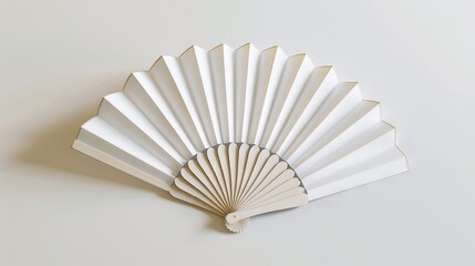 A white paper fan on a table.