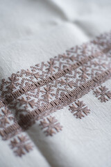 Brown Embroidery Stitch Detail on White Fabric. Traditional Ukrainian embroidery
