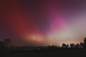 Pink, yellow and red aurora dancing over the Czech Republic. A great solar storm. Night sky under a geomagnetic storm turning pink. A miracle in the Czech Republic. Northern lights