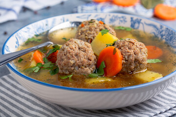 Soup with large meatballs.