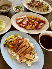 Vertical photo set of that street food, pork leg with rice, crispy and red pork on dish.