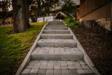 Blome, Latvia - September 11, 2023 - Stone steps leading up a hill, flanked by grass and trees,...