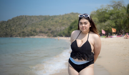 Portrait young asian woman fat chubby cute beautiful smile happy fun enjoy relax bikini swimwear body sexy front view sea beach white sand clean bluesky calm nature ocean wave water travel on holiday