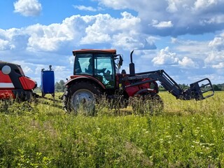 Hay collection in the field by tractor