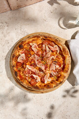 Delicious Meat Pizza with Bacon and Salami in Summer Sunlight and Shadows