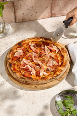 Delicious Meat Pizza with Bacon and Salami in Summer Sunlight and Shadows