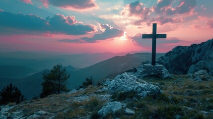 The crucifix symbol of Jesus on the mountain sunset sky background