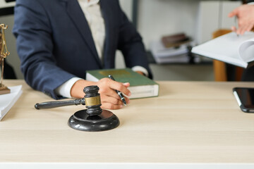 judge on wooden table And experienced lawyers meet with clients and give advice behind the scenes. legal services legal consulting concept