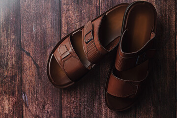 Men's leather slippers on a wooden surface. Men's shoes