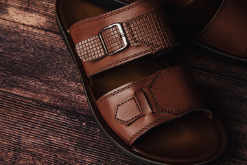 Men's leather slippers on a wooden surface. Men's shoes
