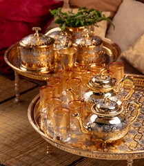 Ornate Golden Moroccan Teapots and Glasses With Dates on a Tray