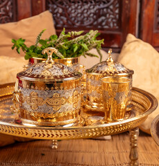 Ornate Golden Moroccan Teapots and Glasses With Dates on a Tray