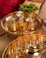 Ornate Golden Moroccan Teapots and Glasses With Dates on a Tray