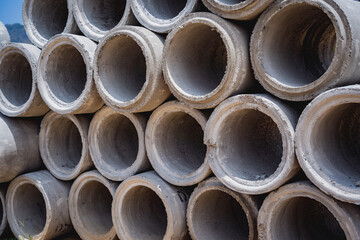 A stack of concrete ring pipes piled and creating a symmetrical arrangement