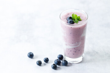 Blueberry smoothie with yogurt in a glass.