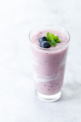 Blueberry smoothie with yogurt in a glass.