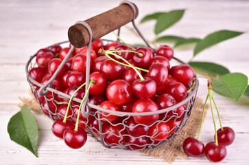 Fresh cherries in a basket on a white background. Close-up.
