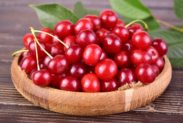 Fresh sour cherries on a wooden tray.Close-up.
