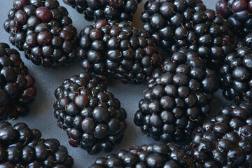 Close up photograph of fresh nutritious blackberry. Shot with a macro lens. Blackberries are superfood with vitamins, minerals, fibre, and antioxidants. Berries background. 
