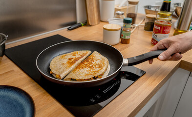 Chef at the kitchen preparing quesadillas with tofu and sweet corn