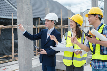 engineers or business partners on a construction site, discussing project details.