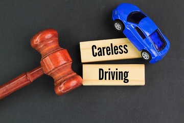 judge's gavel, car and stick with the word careless driving. driving without reasonable...