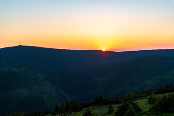 Sunset bellow Vozka hill from Cervena hora hill in Jeseniky mountains in Czech republic