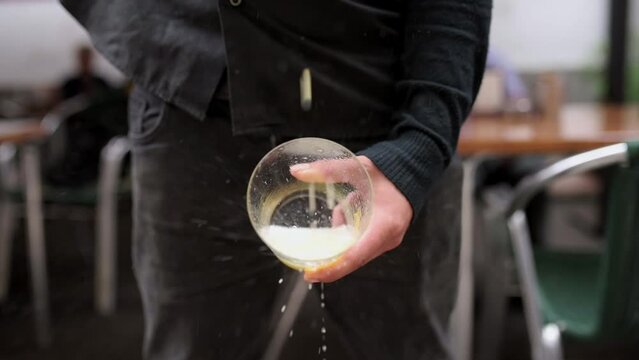 unrecognizable man holding a crystal glass in his hand and pouring Asturian apple cider over it. Tradition from the north of Spain. Typical alcoholic beverage from Asturias, Spain.