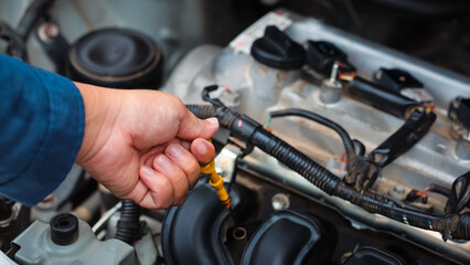 Car care and service A technician is troubleshooting an engine. Spare parts of car engines that have problems and support car insurance services, standard car repair service center concepts.