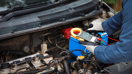 Car care and service A technician is troubleshooting an engine. Spare parts of car engines that have problems and support car insurance services, standard car repair service center concepts.