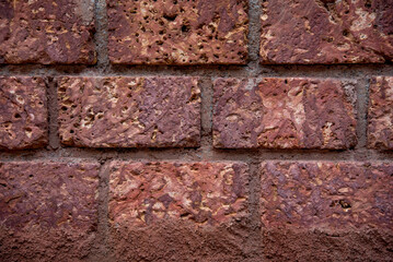 Laterite red stone wall background. Brick wall for background.