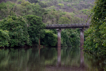 Fototapeta premium Landscape. An old bridge on Jog river. Dapoli, Ratnagiri, Maharashtra, India, Asia.