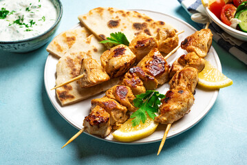 Chicken souvlaki kebabs served with flatbread
