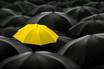 A yellow umbrella amid a crowd of black umbrellas - symbolizing success, leadership, unique identity, innovative ideas, and special skills setting it apart from the rest