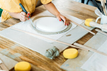 Ceramic workshop. Creating clay fish shapes in a pottery class