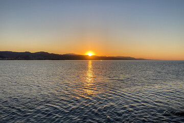 Obraz premium Sunrise over the beach and city in Malaga, Spain