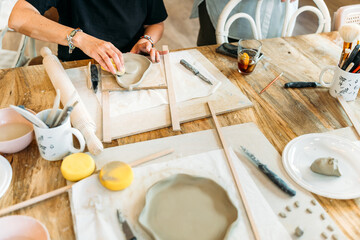 Ceramic workshop. Artists shaping clay in a pottery class
