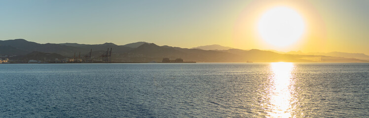 Sunrise over the beach and city in Malaga, Spain