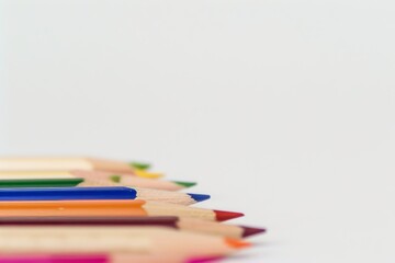 Colorful Pencils Arranged on a White Surface