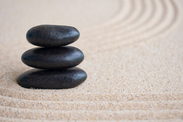 Zen stones stacking on sand with customizable space for text or message