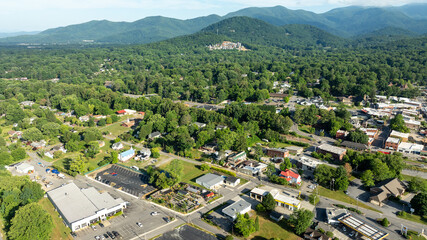 Aerial view of Black Mountain, NC, showcasing a charming town surrounded by lush green forests and mountainous landscape.