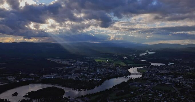 Drone cityscape view of Drammen in Norway with crooked river through the city at sunset with sunrays