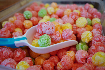 Colorful sugar coated rice balls for sale at market