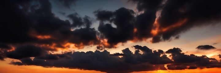 Fototapeta premium Dark Sunset view with dark clouds background wide background 