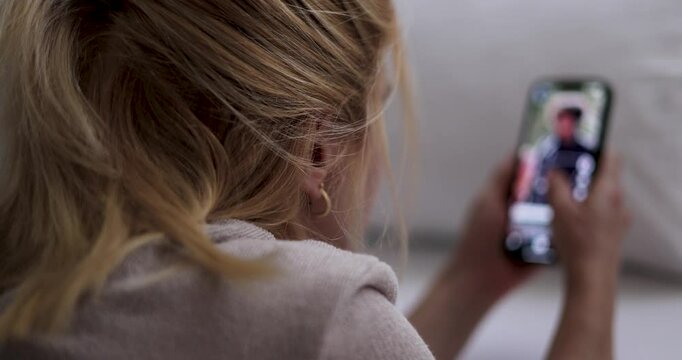Woman Scrolling on Social Media. teenager girl casually scrolling through social media on his smartphone. contemporary habits. addicted to fake news and scrolling on social platforms. screen time.