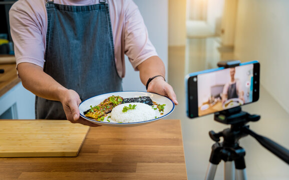 The chef is broadcasting live from workshop how to prepare a grilled eggplants with garlic