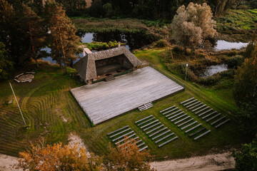 Blome, Latvia - September 11, 2023 - Aerial view of an outdoor amphitheater with wooden benches and...