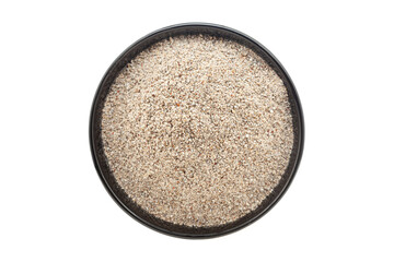 Organic Pearl Millet Flour (Pennisetum glaucum) or Bajra Flour, in a black ceramic bowl. Isolated on a white background. Top View
