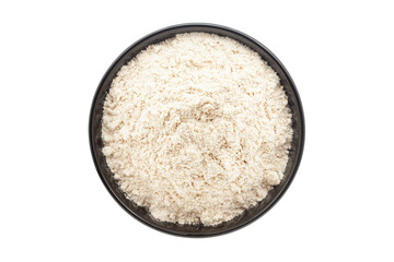 Organic Wheat Flour (Triticum), in a black ceramic bowl. Isolated on a white background. Top View